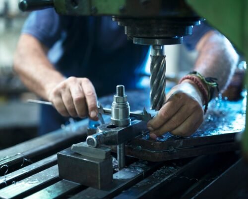 worker-operating-industrial-machine-metal-workshop_342744-268